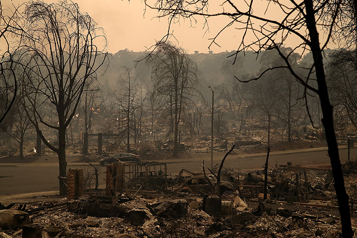 Smoke rises from a neighbourhood that was destroyed by a fast moving wild fire on October 9, 2017 in Santa Rosa, California.