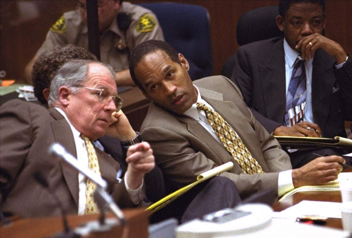 O.J. Simpson and his defence attorney, F. Lee Bailey, left, consult with each other, Friday, June 30, 1995, during the Simpson double-murder trial in Los Angeles. At right is Simpson’s defence attorney Carl Douglas.