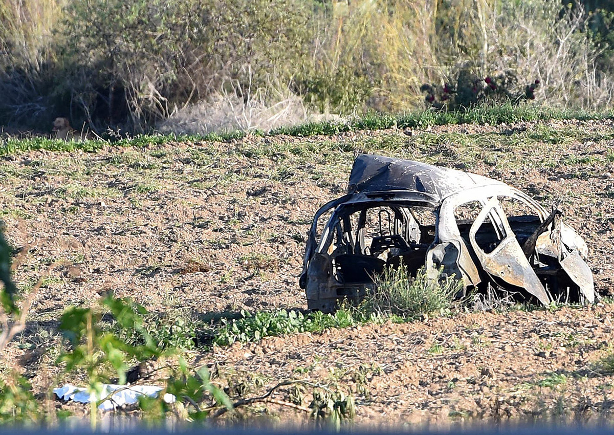 The wreckage of the car of investigative journalist Daphne Caruana Galizia lies next to a road in the town of Mosta, Malta, Monday, Oct. 16, 2017. 