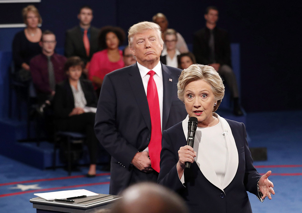 In this Oct. 9, 2016 file photo, Democratic presidential nominee Hillary Clinton, right, speaks as Republican presidential nominee Donald Trump listens during the second presidential debate at Washington University in St. Louis, Sunday, Oct. 9, 2016. 