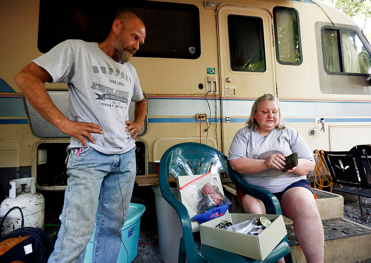Richard Saunders and his wife Angie Saunders look through a box containing favorite items belonging to their son Cody Dale Saunders in Townsend, Tennessee July 23, 2017.