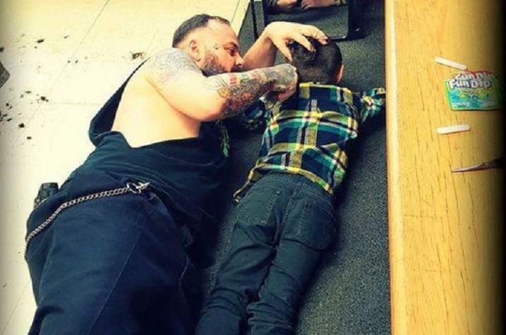 A barber from western Quebec is drawing widespread praise for going out of his way to accommodate a young client with autism. This handout photo, posted online last week, shows Francis "Franz" Jacob lying on the floor of his Rouyn-Noranda shop as he gives a young boy named Wyatt a haircut.
