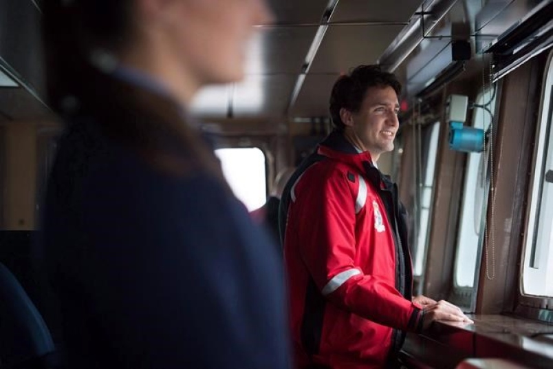 Prime Minister Justin Trudeau stands on the bridge of the Canadian Coast Guard ship Sir Wilfrid Laurier, during a tour of the harbour in Vancouver, B.C., on Monday November 7, 2016. The Trudeau government is promising a much-needed infusion of cash for the Canadian Coast Guard and federal fisheries department, which internal documents show have been struggling with funding shortfalls for years.