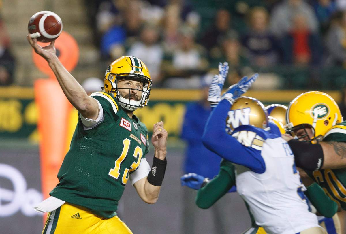 Edmonton Eskimos quarterback Mike Reilly (13) makes the throw against the Winnipeg Blue Bombers during second half CFL action in Edmonton, Alta., on Saturday September 30, 2017. 