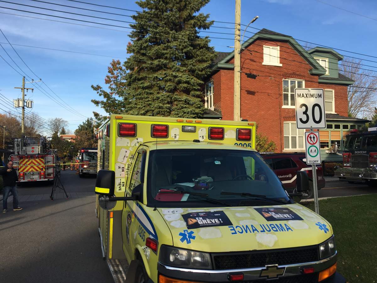 Firefighters and police officer investigate after white powder flew out of an envelope being delivered by a Canada Post employee in Senneville, Que., Friday, Oct. 27, 2017.