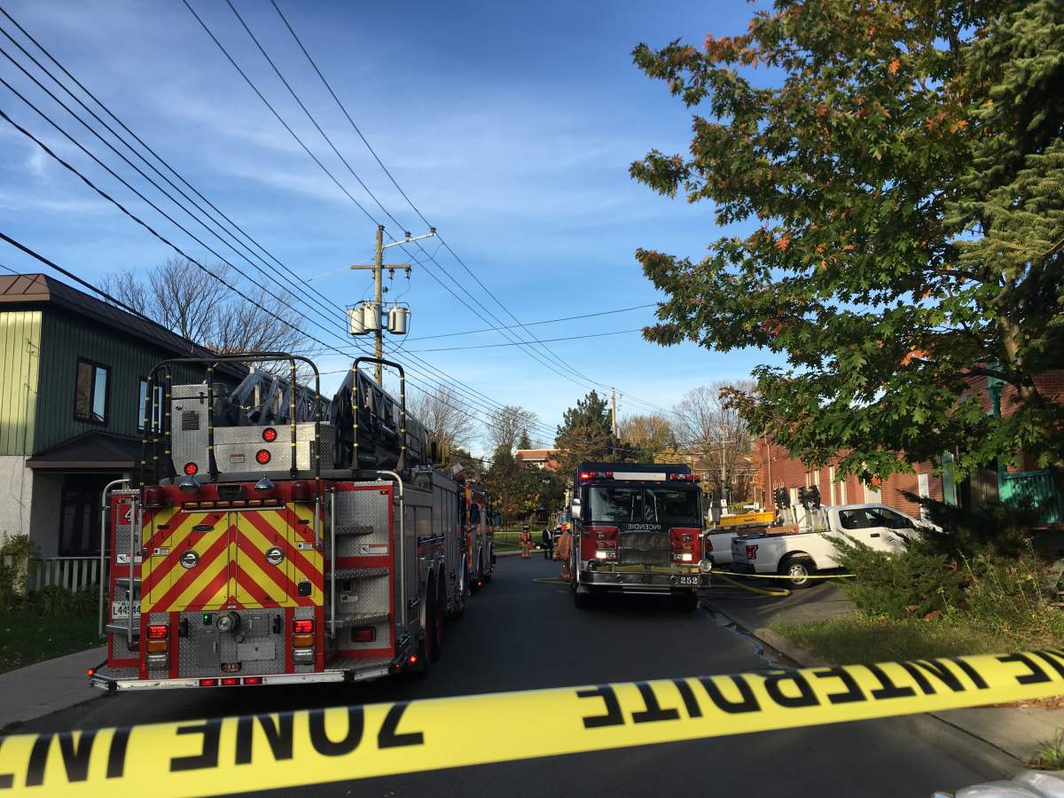 Firefighters and police officer investigate after white powder flew out of an envelope being delivered by a Canada Post employee in Senneville, Que., Friday, Oct. 27, 2017.