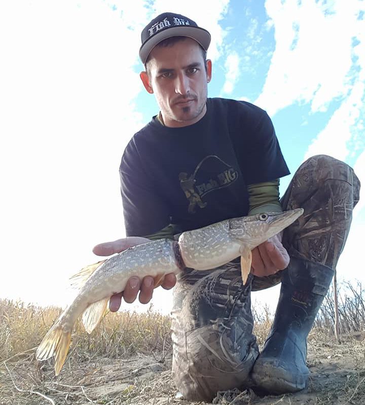 Adam Turnbull, 28, holding the Northern Pike/ jackfish he caught from the South Saskatchewan River in Medicine Hat, Alta. on Saturday, Oct. 28, 2017.