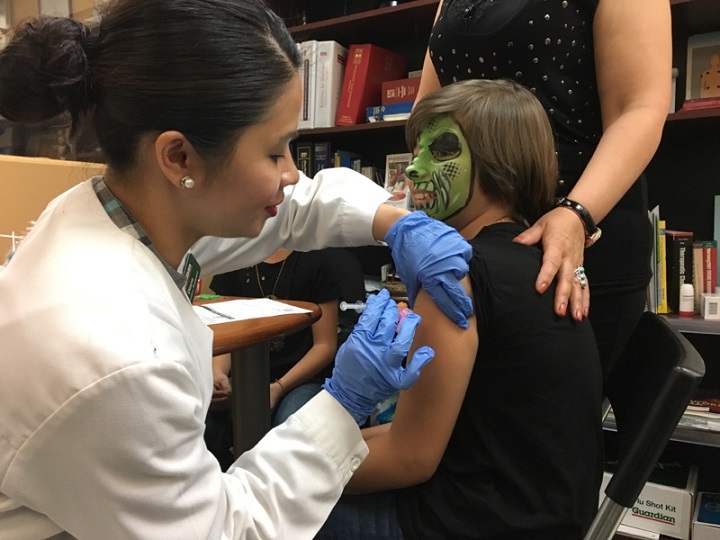 A child is given a free flu shot at a local pharmacy in Scarborough.