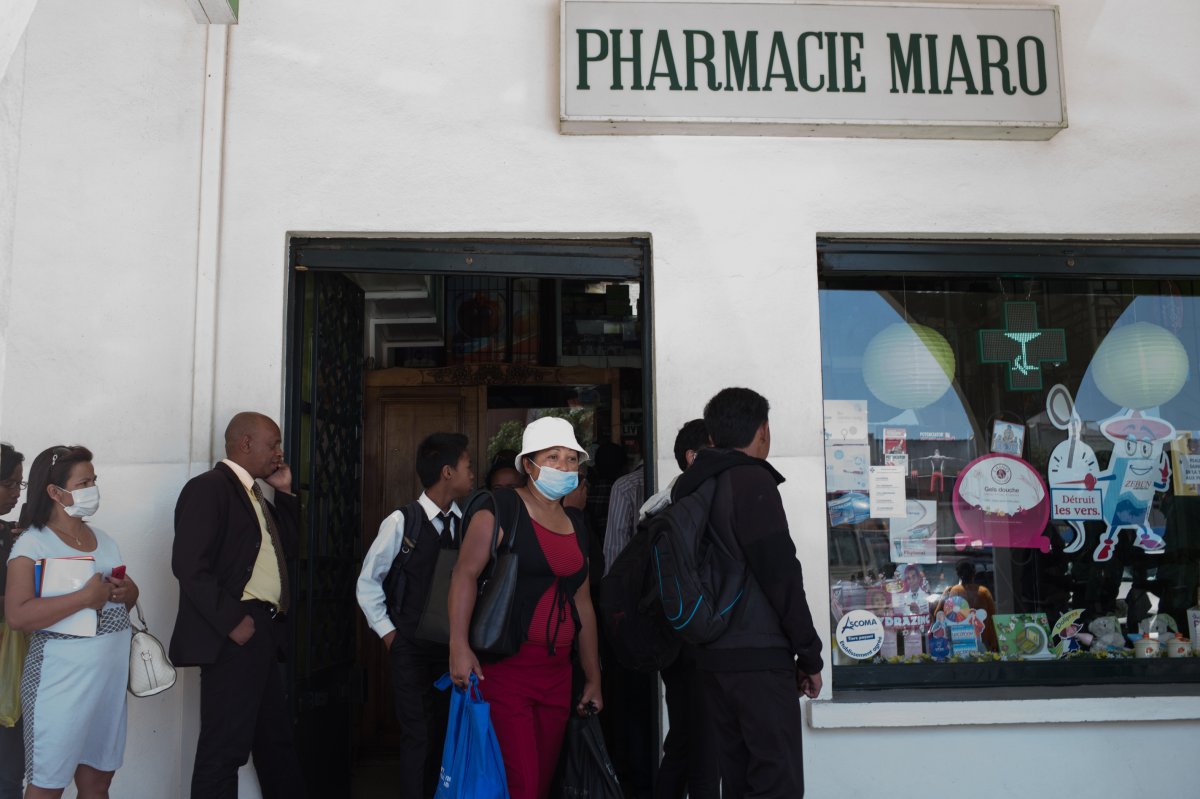 People queue at a pharmacy in downtown Antananarivo, Madagascar to buy protection masks against infections and medicines against plague.