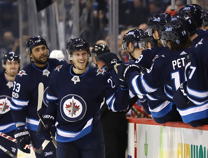 Nikolaj Ehlers of the Winnipeg Jets celebrates his third period goal against the Carolina Hurricanes with teammates at Bell MTS Place on Oct. 14, 2017 in Winnipeg.