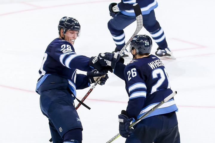 Patrik Laine (left) and Blake Wheeler of the Winnipeg Jets celebrate a second period goal against the Minnesota Wild at Bell MTS Place on Oct. 20, 2017 in Winnipeg.