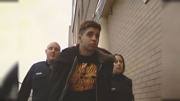 Nicholas Hovanesian while being walked to the arrest processing unit in Calgary Oct. 3, 2009.