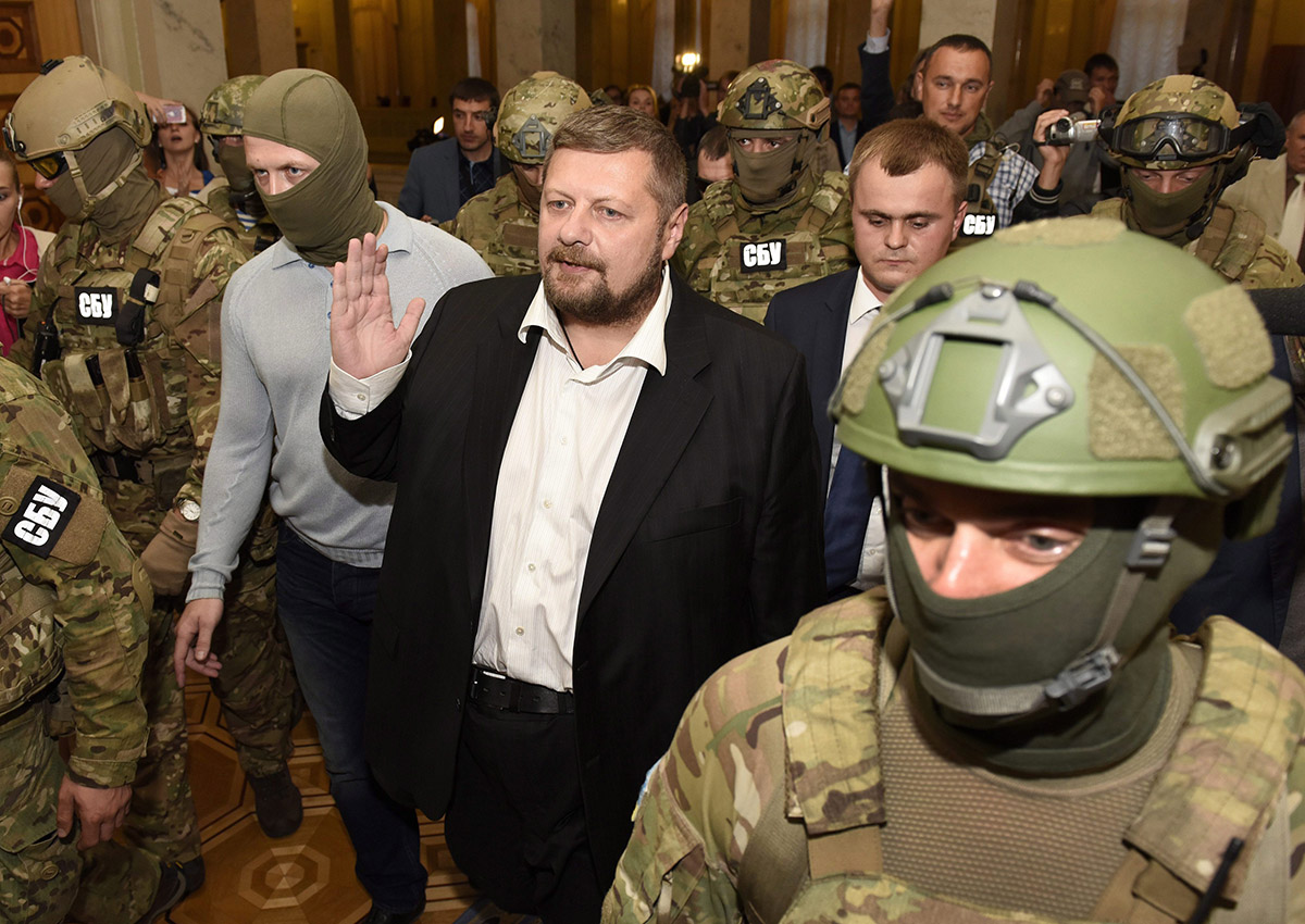 Ukrainian Secret Service officers arrest lawmaker Ihor Mosiychuk, center, a member of the Radical Party faction, walks in the Parliament hall, during a session in Kiev, Ukraine, Thursday, Sept. 17, 2015.