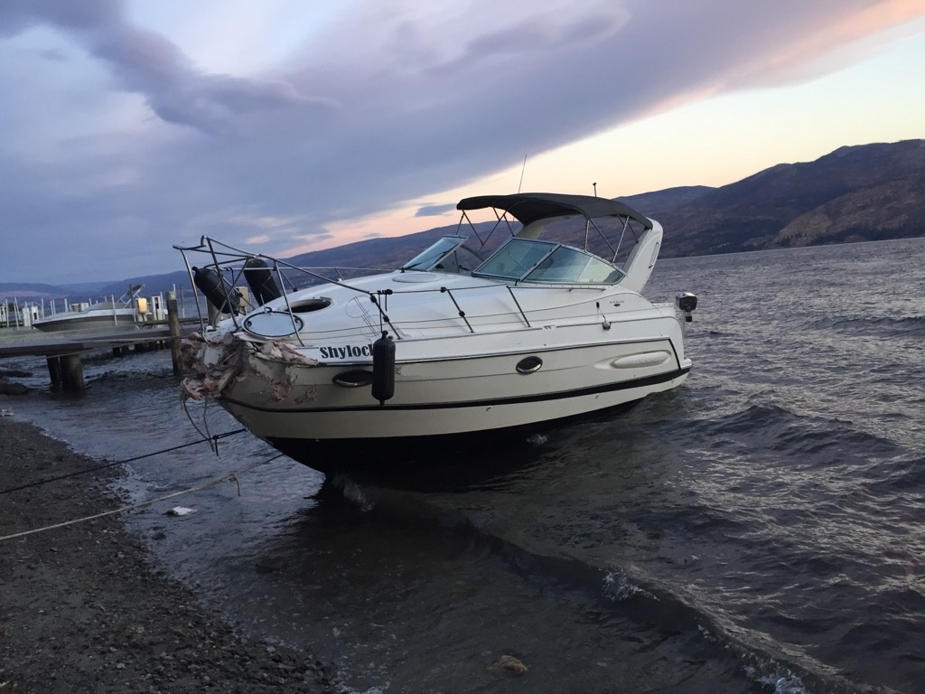 A boat ran aground  on Okanagan Lake after the driver fell into the water Sunday.