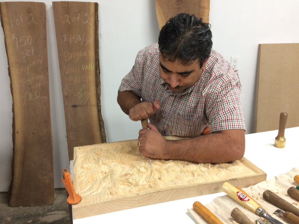 Yousef Al Kurdi works on a carving for Lori Joseph at the London Community Woodshop on Thursday, Oct. 12, 2017.