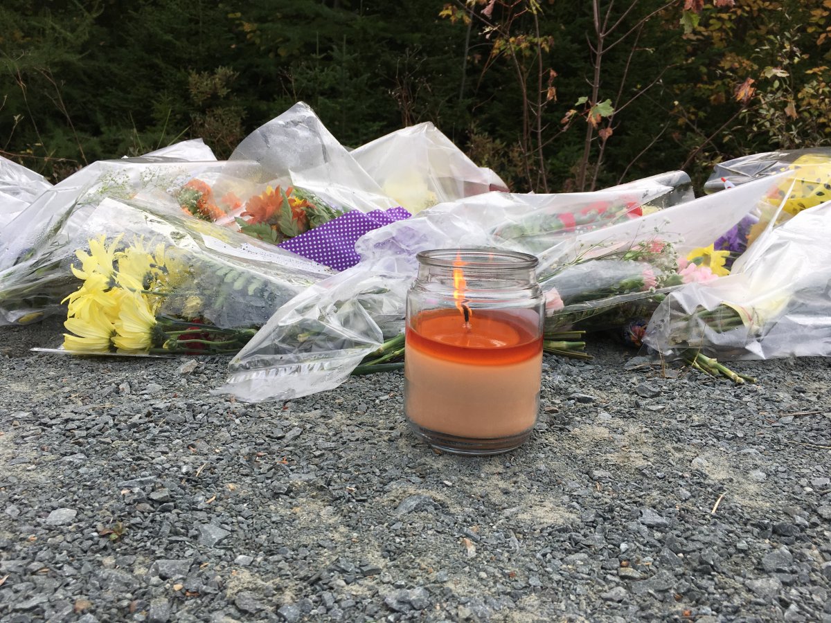 A candle burns on Sunday near the scene of a fatal accident in Hammonds Plains, N.S.