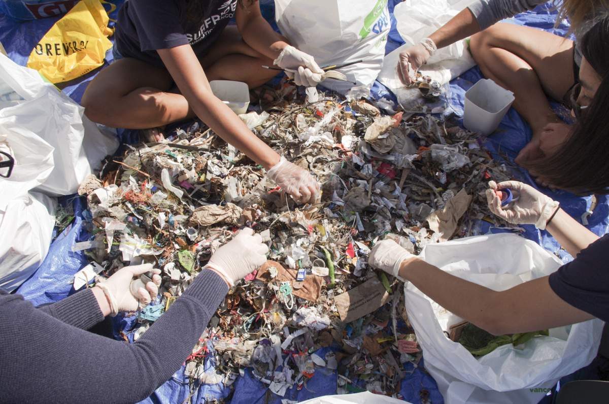 Volunteers sort through garbage collected at Kitsilano Beach.