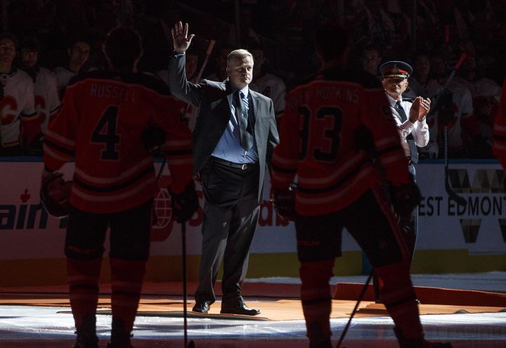 Const. Michael Chernyk waves to the crowd as he is honoured during the Calgary Flames and Edmonton Oilers game in Edmonton, Alta., on Wednesday October 4, 2017. Const. Michael Chernyk was hit by a car and stabbed during a recent attack.