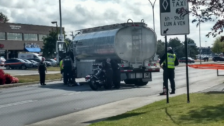 Police investigate after a man was critically injured when his motorcycle collided with a tanker truck in Dollard-des-Ormeaux. Thursday, Oct. 5, 2017.