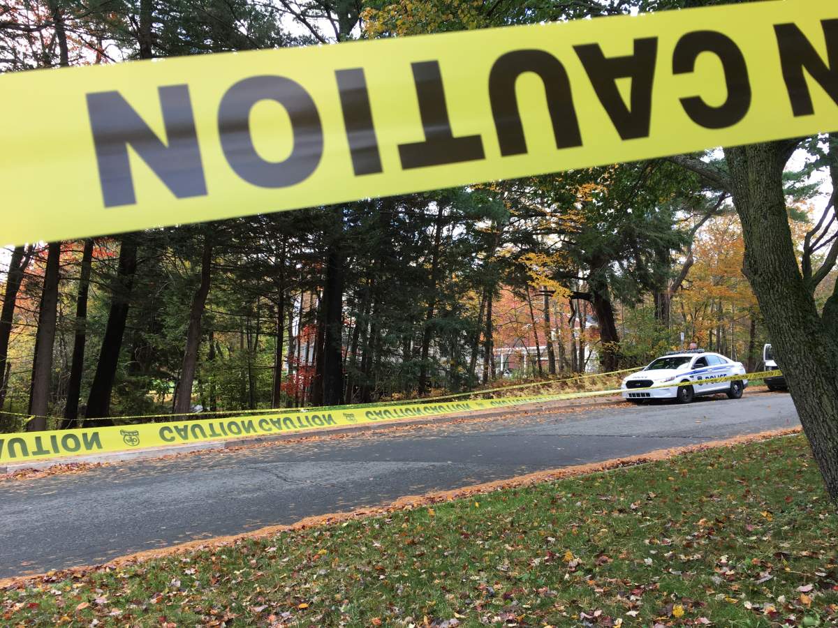 Police are on scene collecting evidence in a wooded area at the campus.