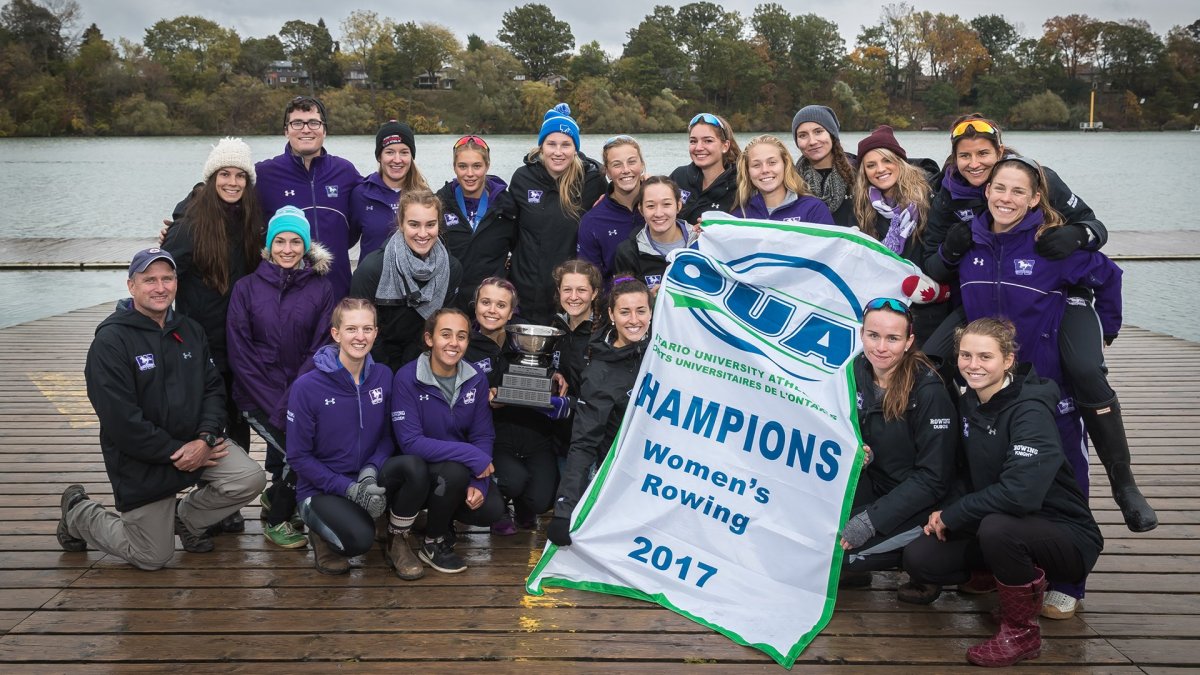 The Western Mustang women's rowing team poses for a picture on the dock following their OUA championship on Oct. 28, 2017.