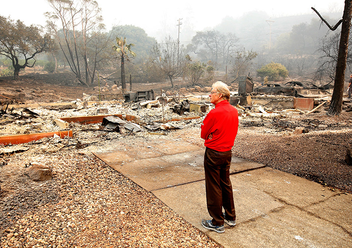 Mike Rippey looks over the burned remains of his parent’s home at the Silverado Resort, Tuesday, Oct. 10, 2017, in Napa, California.