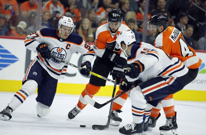 Edmonton Oilers' Connor McDavid, left, Philadelphia Flyers' Valtteri Filppula, Oilers' Patrick Maroon and Flyers' Andrew MacDonald, battle for control of the puck during the second period of an NHL hockey game, Saturday, Oct. 21, 2017, in Philadelphia. 