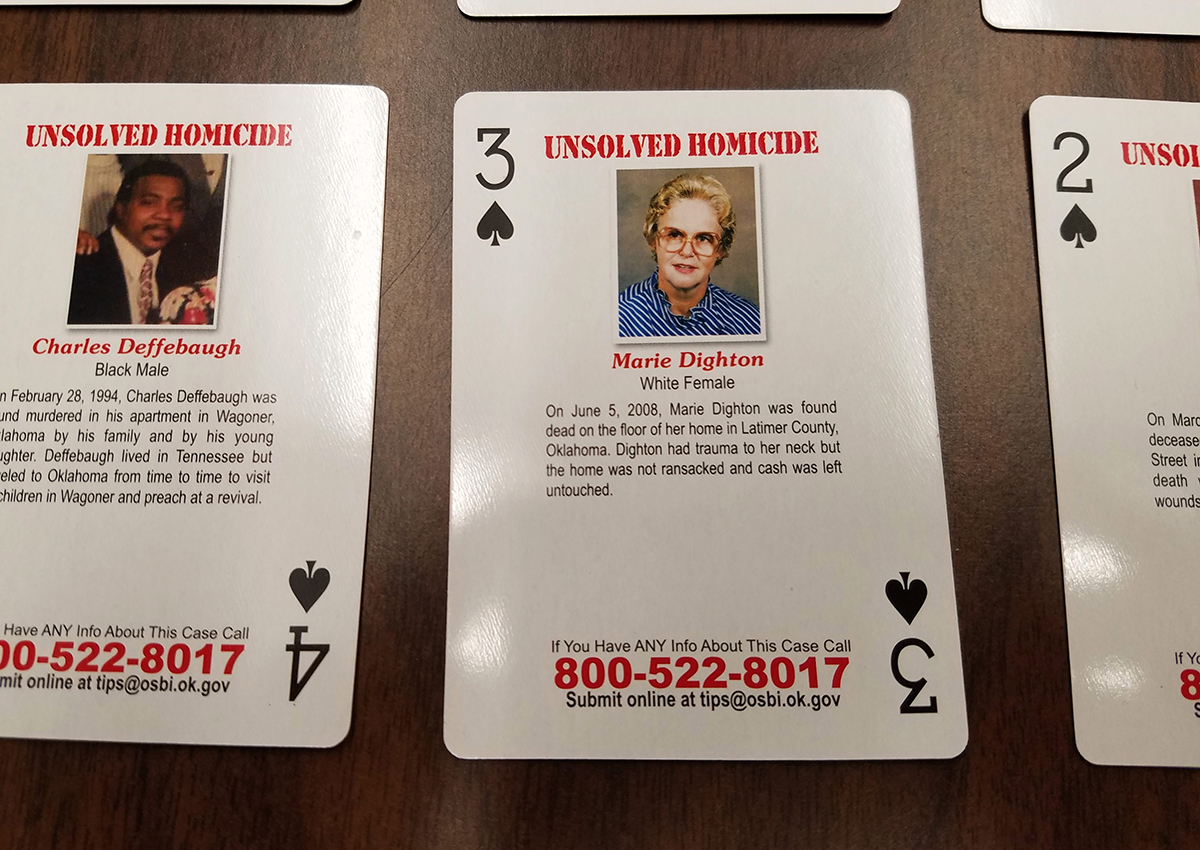 Playing cards featuring unsolved and unidentified homicides or missing person cases are displayed at Oklahoma State Bureau of Investigation headquarters in Oklahoma City, Wednesday, Oct. 11, 2017.