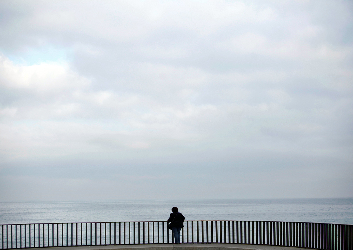 A woman leans over a viewpoint at the prominade of A Coruna, province of Galicia, northwestern Spain, 13 October 2017. 