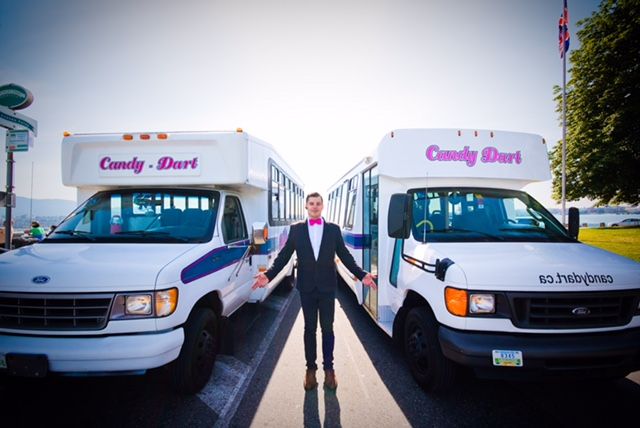 Rami Ladki, standing between two buses that formed part of his “Candy Dart” charter business.