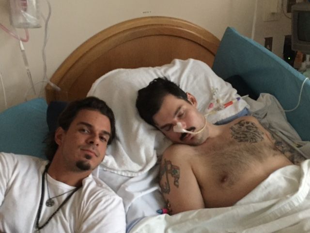 Rami Ladki, right, in bed, with his brother by his side.