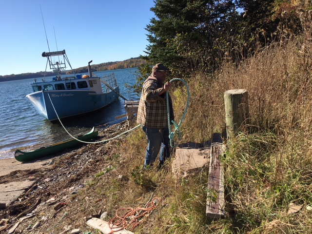 Ray Wagner, a lobster fisherman, ties up his boat