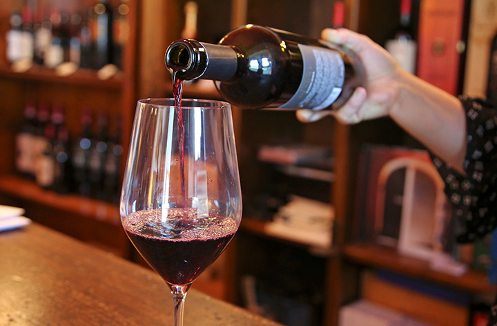 A sommelier pours a glass of red wine in this undated file photo. 