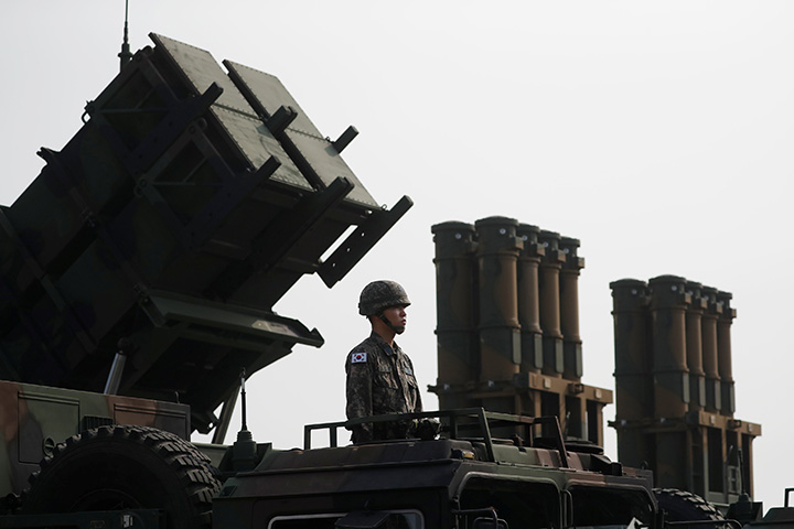 A soldier stands on a PAC-2 launcher (L) next to medium-range surface-to-air missiles during a photo opportunity ahead of a celebration to mark the 69th anniversary of Korea Armed Forces Day, in Pyeongtaek, September 25, 2017. 