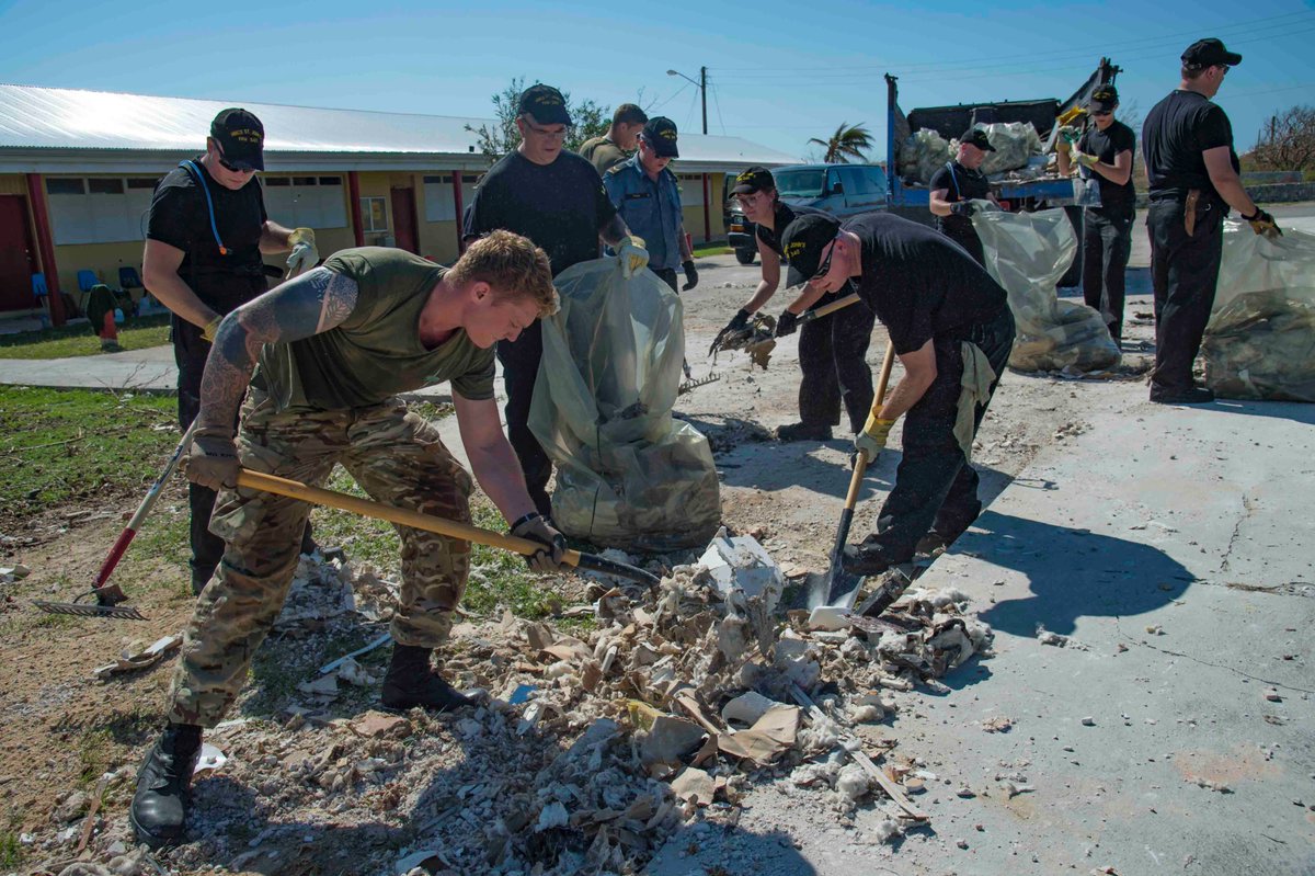 The crew of HMCS St. John's and Royal Marines members work together to clean up a school in South Caicos Island in the aftermath of Hurricane Irma on Sept. 18.