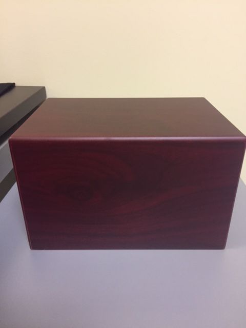 Police have recovered this red wooden urn, which was stolen during a break-in at a Didsbury, Alta.-area home on Thursday, Oct. 12, 2017.