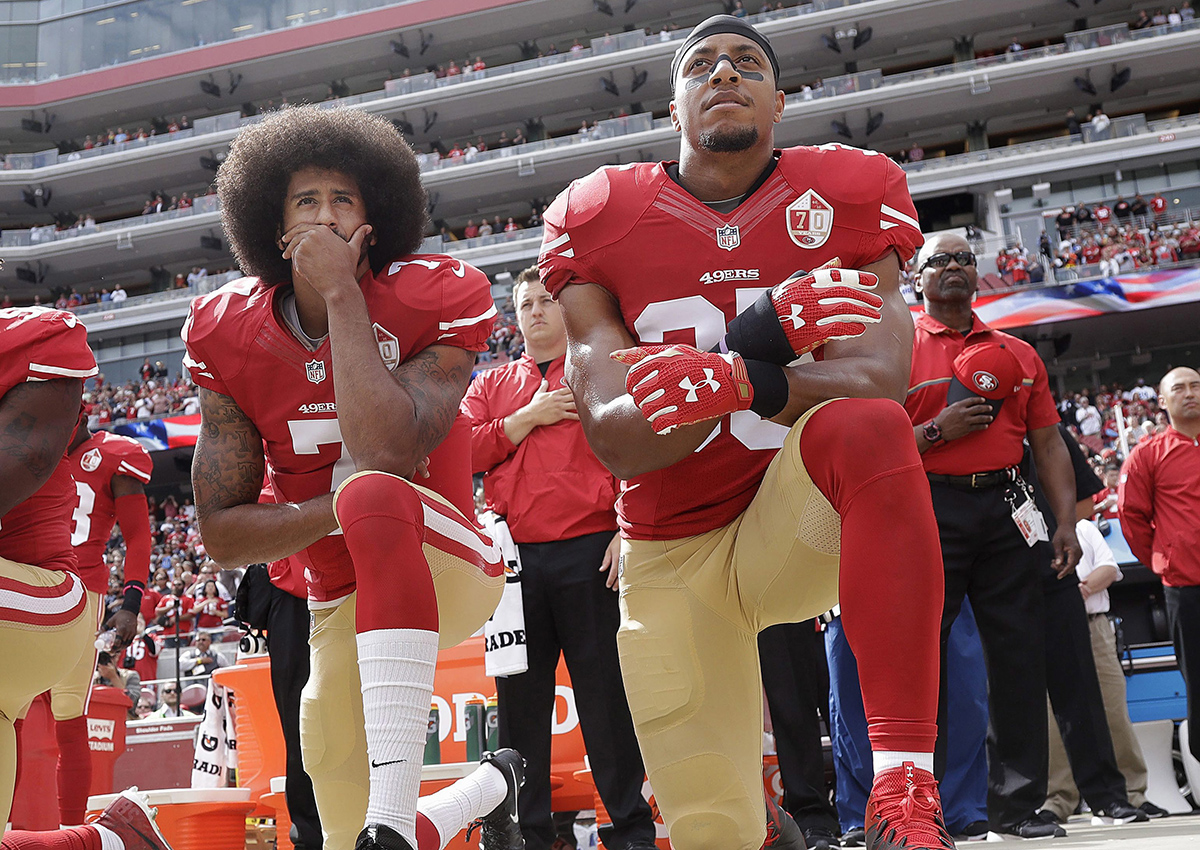  In this Oct. 2, 2016 file photo, San Francisco quarterback Colin Kaepernick, left, and safety Eric Reid kneel during the national anthem before an NFL football game against the Dallas Cowboys in Santa Clara, Calif.
