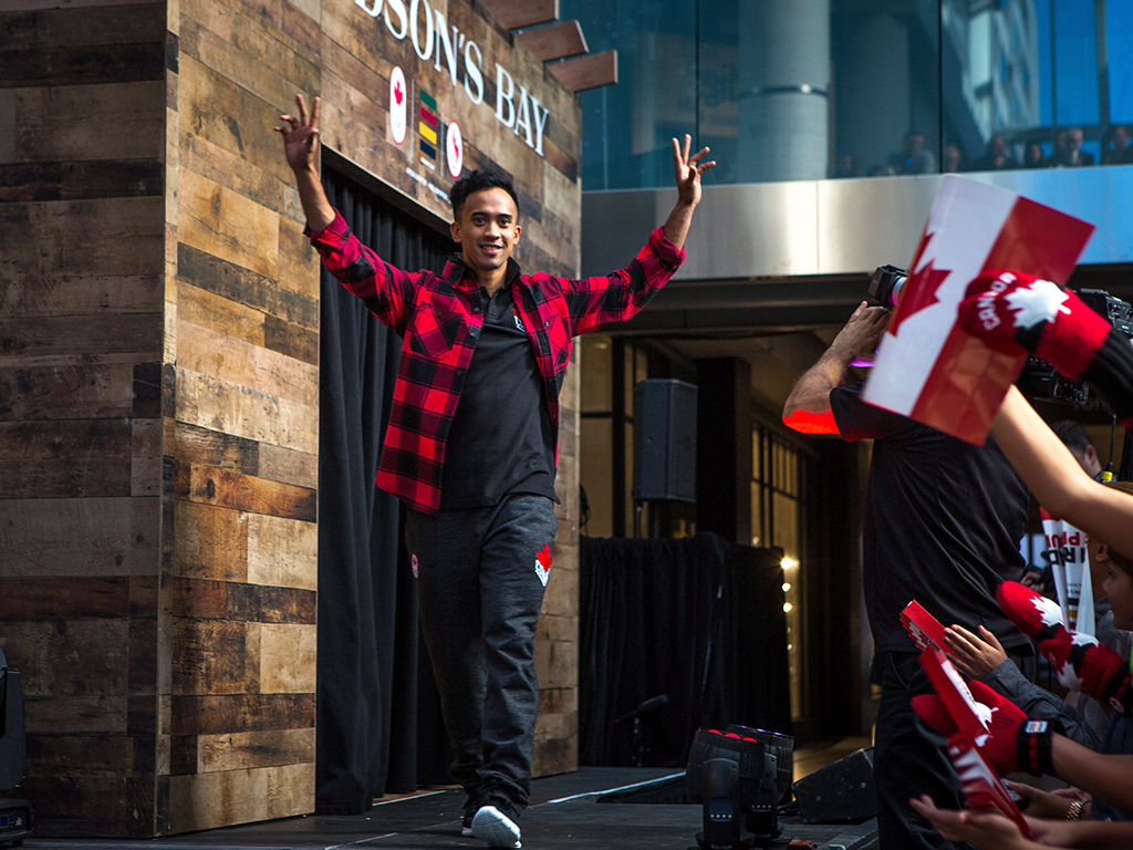 Olympian Gilmore Junio shows off HBC's new line of Olympic gear.  