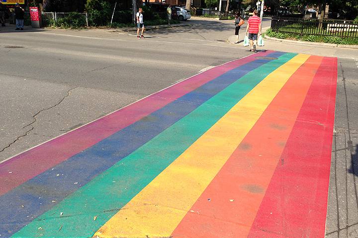The pride rainbow, seen here in Toronto's pride crosswalk, was created by Gilbert Baker and consists of either six or eight colours.