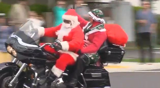 Santa roars away on his motorcycle at the 39th annual Christmas Toy Run Sunday.