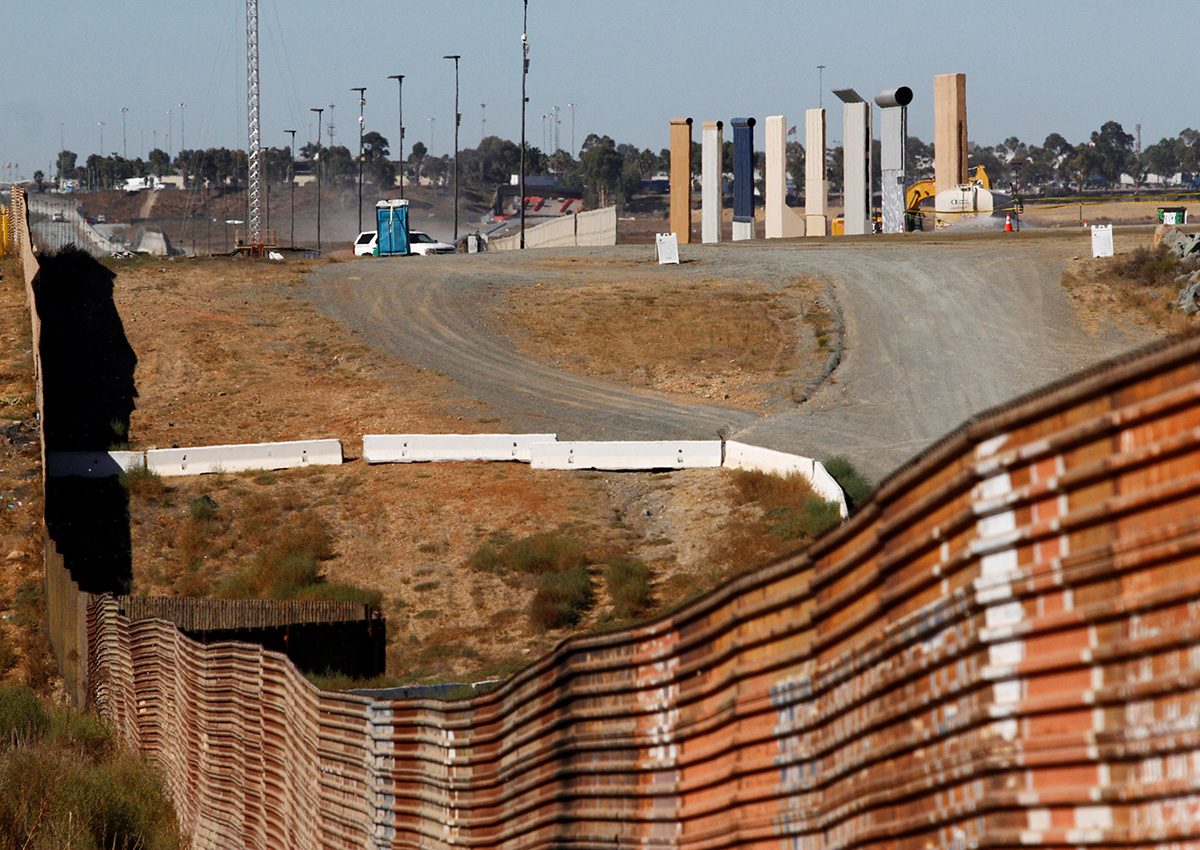 Prototypes (R) for U.S. President Donald Trump's border wall with Mexico are shown near completion behind the current border fence, in this picture taken from the Mexican side of the border, in Tijuana, Mexico, October 23, 2017.