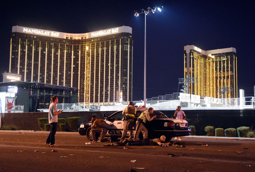 Las Vegas police stand guard along the streets outside the Route 91 Harvest Country music festival grounds of the Route 91 Harvest on October 1, 2017 in Las Vegas, Nevada.  There are reports of an active shooter around the Mandalay Bay Resort and Casino.