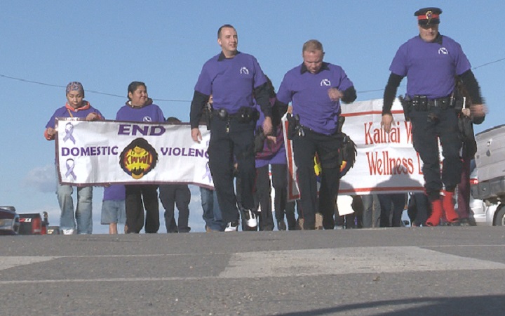 Some Blood Tribe Police Officers strapped on high heels Tuesday morning for the second annual Walk in her Shoes event.