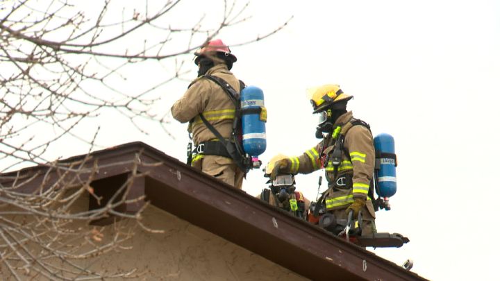 Firefighters on the roof of a house fire on Whiteview Close N.E. in Calgary on Oct. 24, 2017.