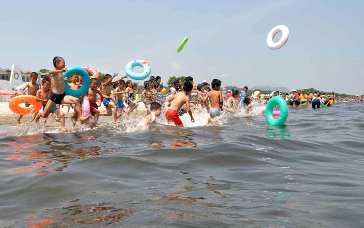 Schoolchildren play in the water