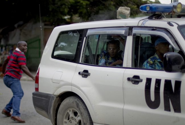 A man throws a block of cement at a UN vehicle in Haiti, Sept. 8, 2011, during a demonstration over allegations of Uruguayan peacekeepers sexually abusing a young Haitian man. 


