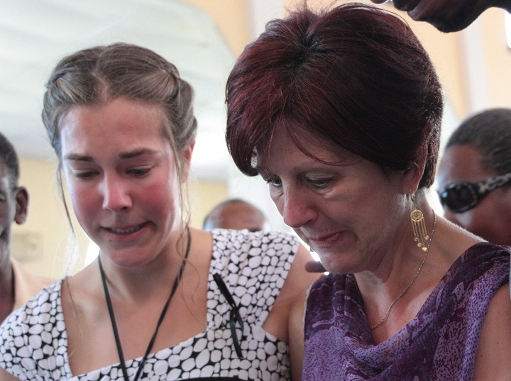  Dolette Cyr Bartholomew (right), wife of Oscar Bartholomew, and her daughter Jacynthe  grieve at a funeral service for Oscar in Crochu, Grenada, Monday, Jan.9, 2012. Bartholomew died in police custody after his arrest in Grenada on Boxing Day. 