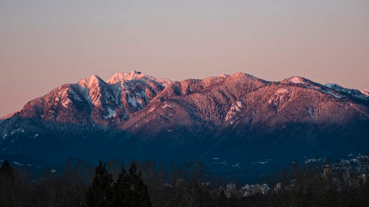 Sunset colours on Vancouver's snow-capped North Shore Mountains, Vancouver, B.C., January 2, 2017. 
