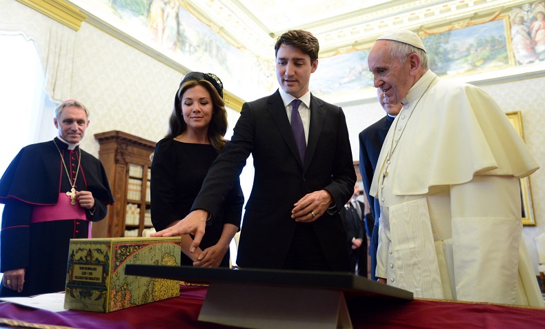 Prime Minister Justin Trudeau presents a gift with wife Sophie Gregoire Trudeau meet with Pope Francis for a private audience at the Vatican on Monday, May 29, 2017. 