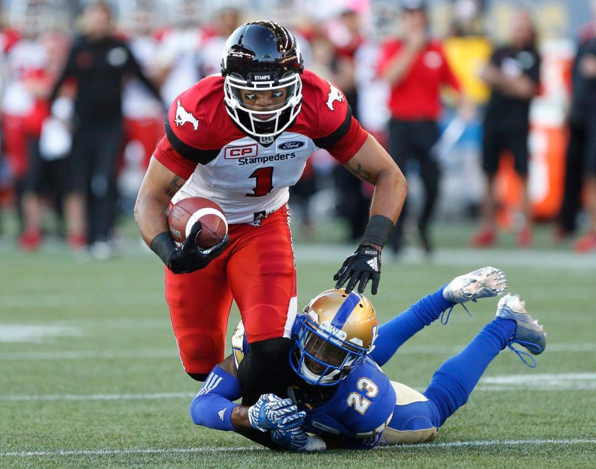 Calgary Stampeders’ Lemar Durant (1) gets stopped by Winnipeg Blue Bombers’ TJ Heath (23) during the first half of CFL action in Winnipeg Friday, July 7, 2017. THE CANADIAN PRESS/John Woods